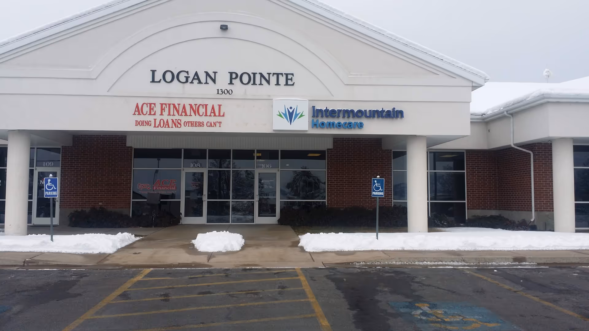 Front view of Logan Pointe storefront with Intermountain Homecare signage and snow in the parking area.