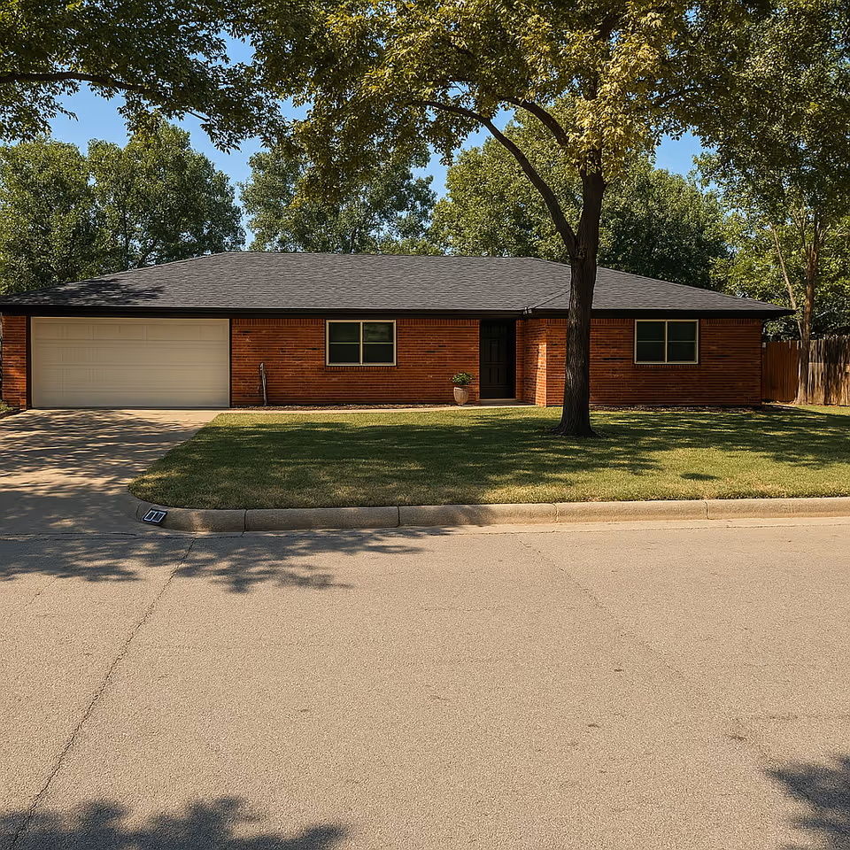 Single-story brick building with attached garage, front lawn, and a large tree in the yard.