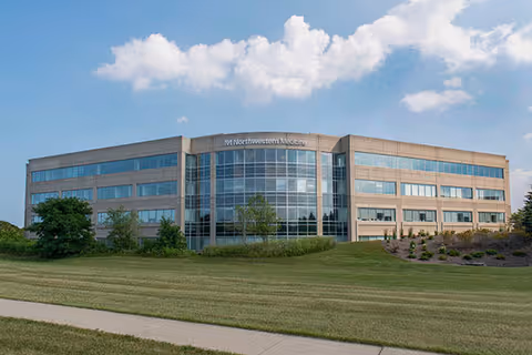 Facade of Northwestern Medicine Infusion Center Glenview, a modern glass-front building with landscaping.