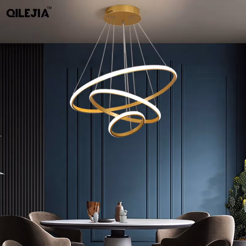 Modern blue dining area with circular pendant light above a round table and chairs.
