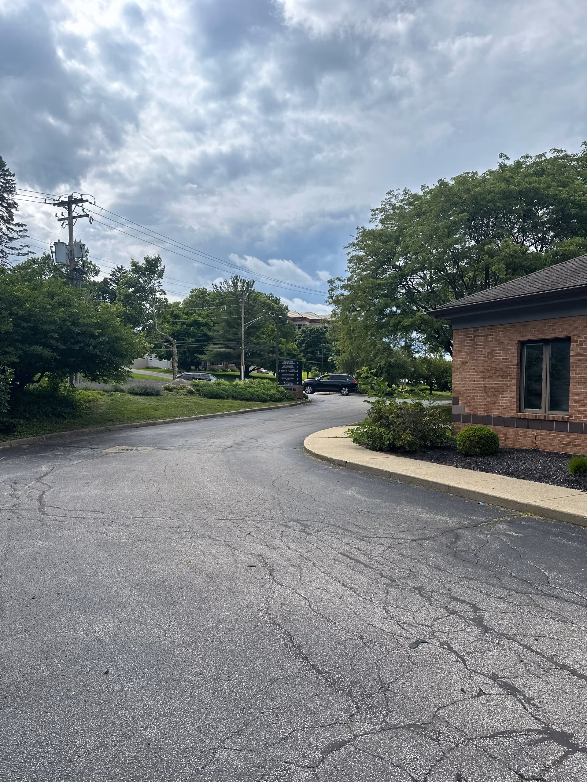 Exterior view of a brick senior care facility with landscaping.