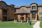 An exterior courtyard with a gazebo and a tan, multi-story senior living building.