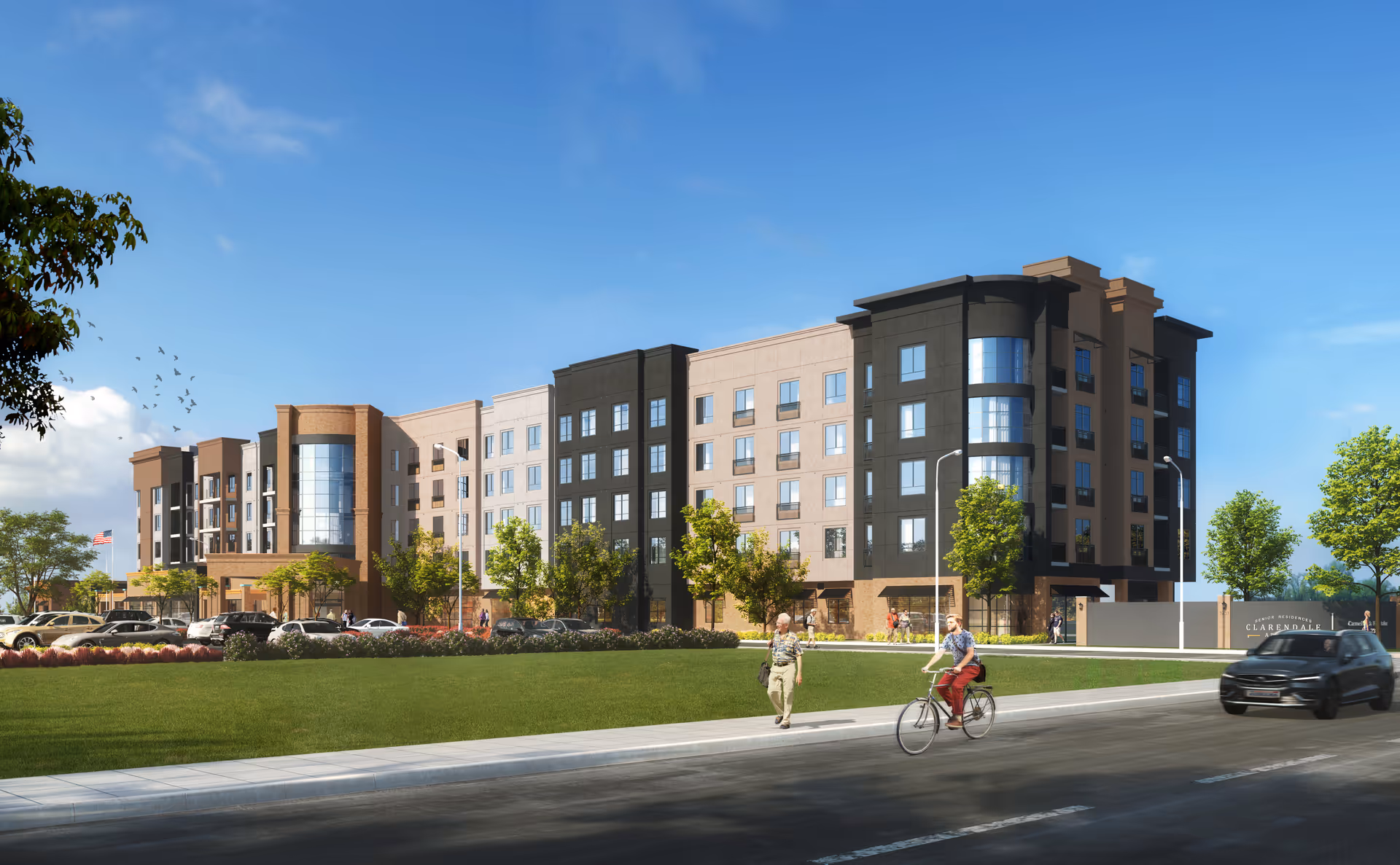 Front view of a modern multi-story senior living facility with curved glass entrance