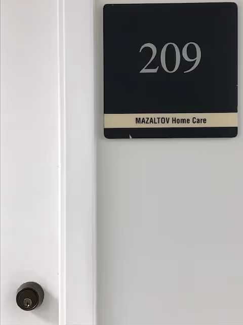 Door labeled 209 with Mazaltov Home Care sign on a wall.