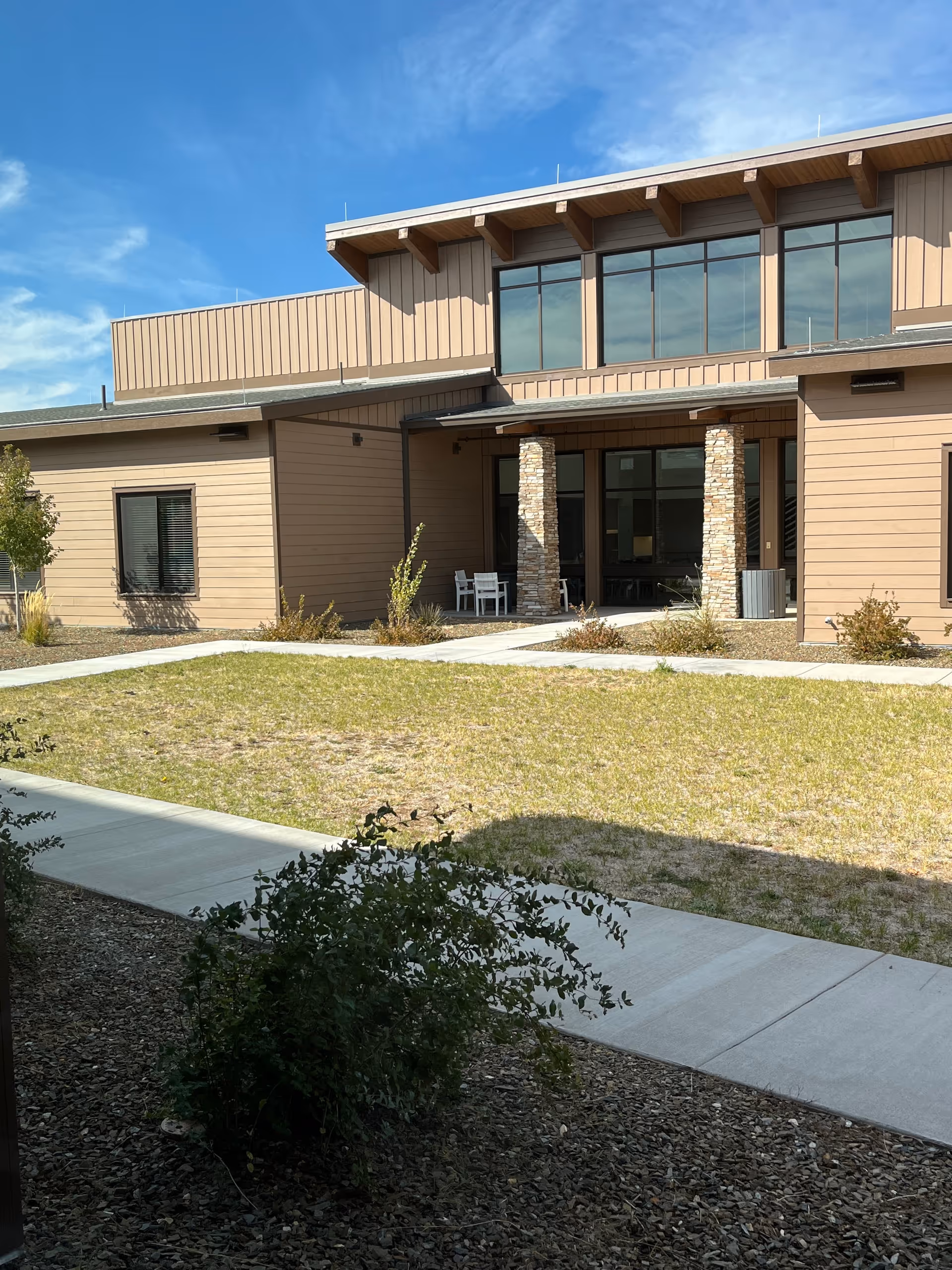 Front exterior of Arizona State Veteran Home in Flagstaff, with stone columns.