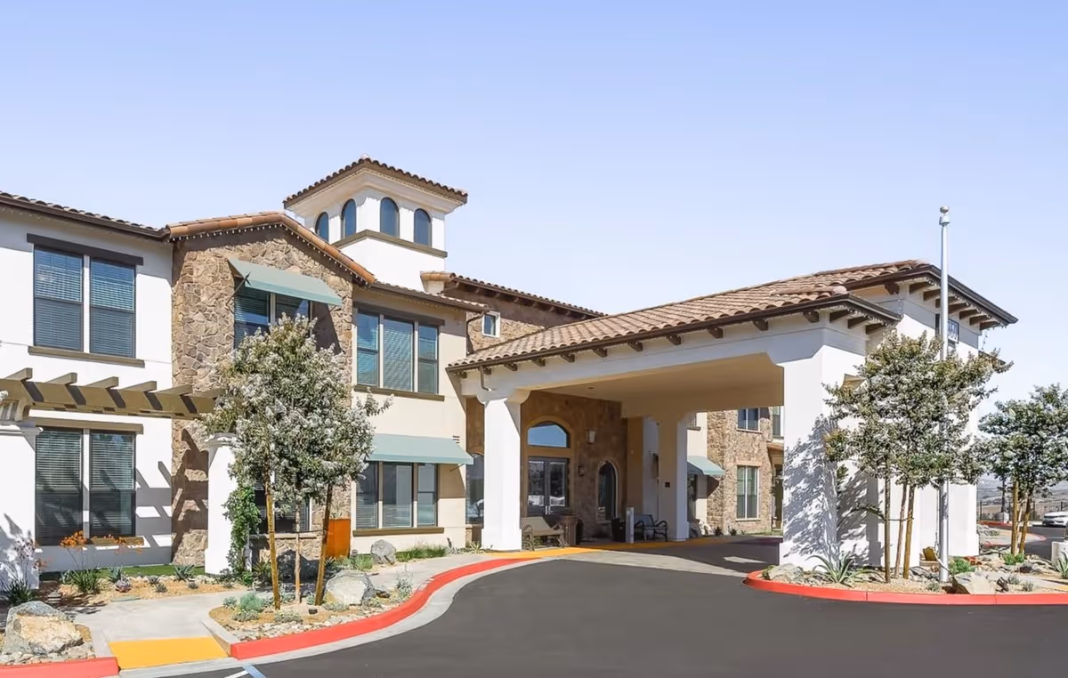 Front view of Laurel Heights Senior Living & Memory Care building with covered entrance.