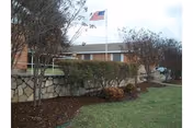 Exterior view of Trinity Nursing & Rehabilitation of Granbury with flag.