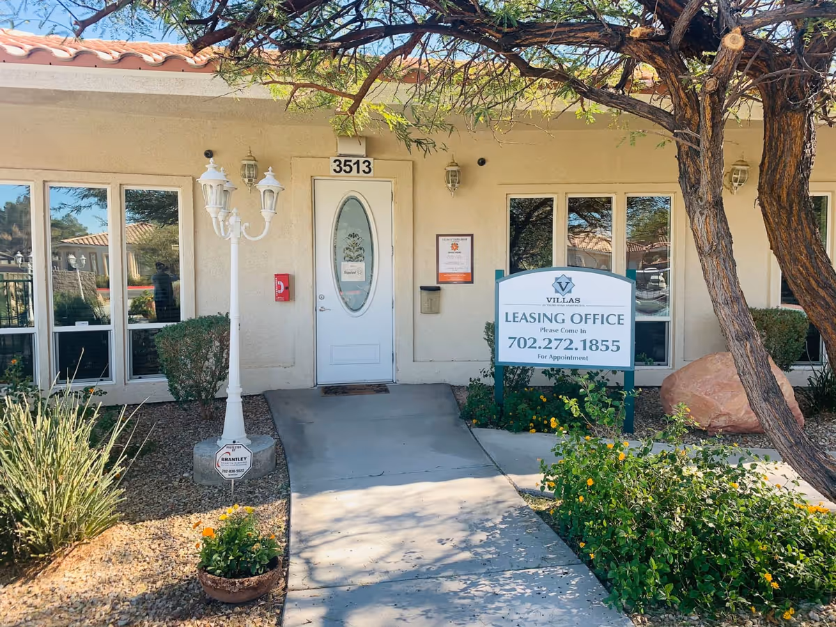 Front entrance of Villas at Viking Road leasing office with sign and landscaping.