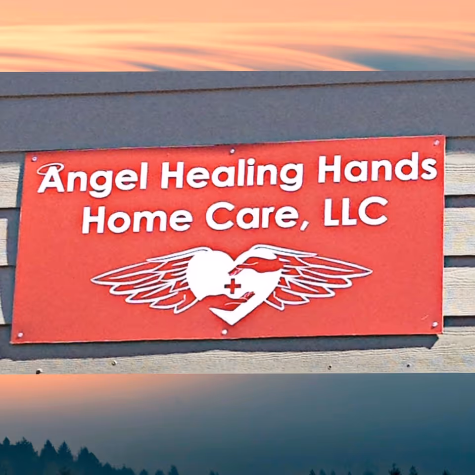 Red sign on building reads Angel Healing Hands Home Care, LLC with winged heart logo.