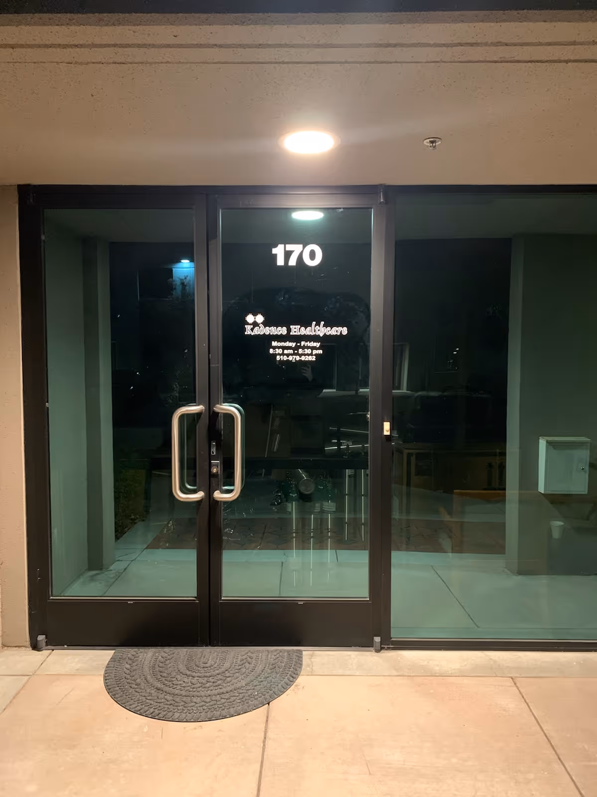 Glass double doors with Kadence Healthcare logo and the number 170.