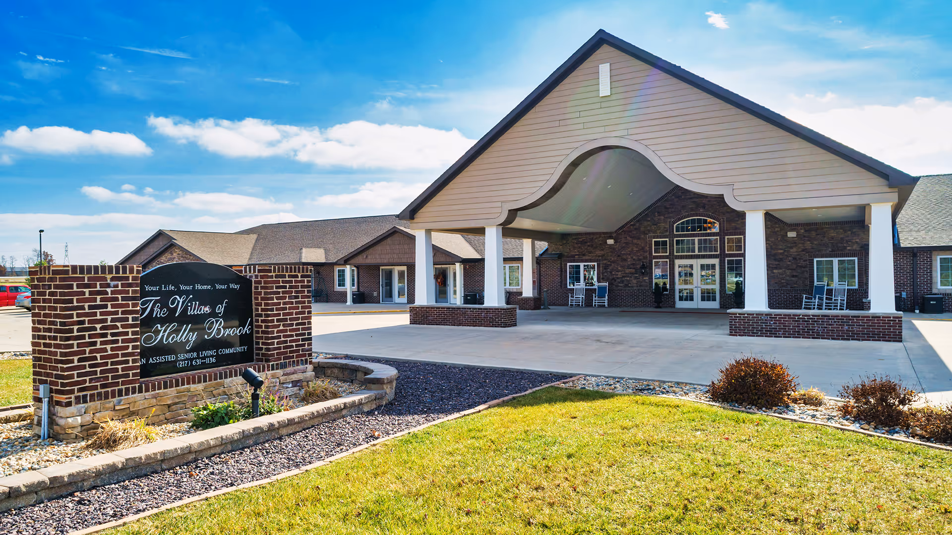 Exterior view of Monticello Villas of Holly Brook entrance with brick facade and signage