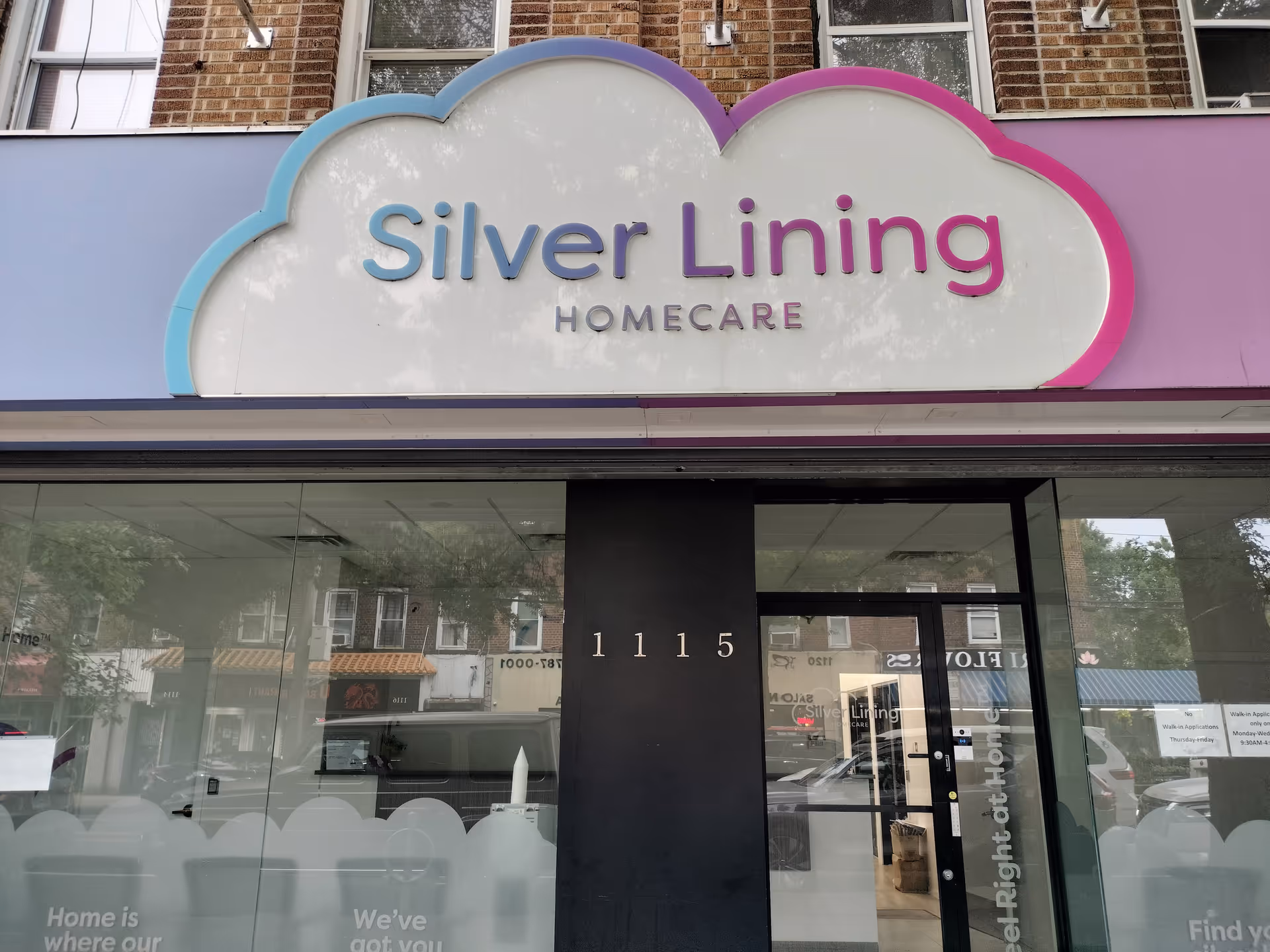 Storefront with cloud-shaped sign reading Silver Lining Homecare above glass doors.