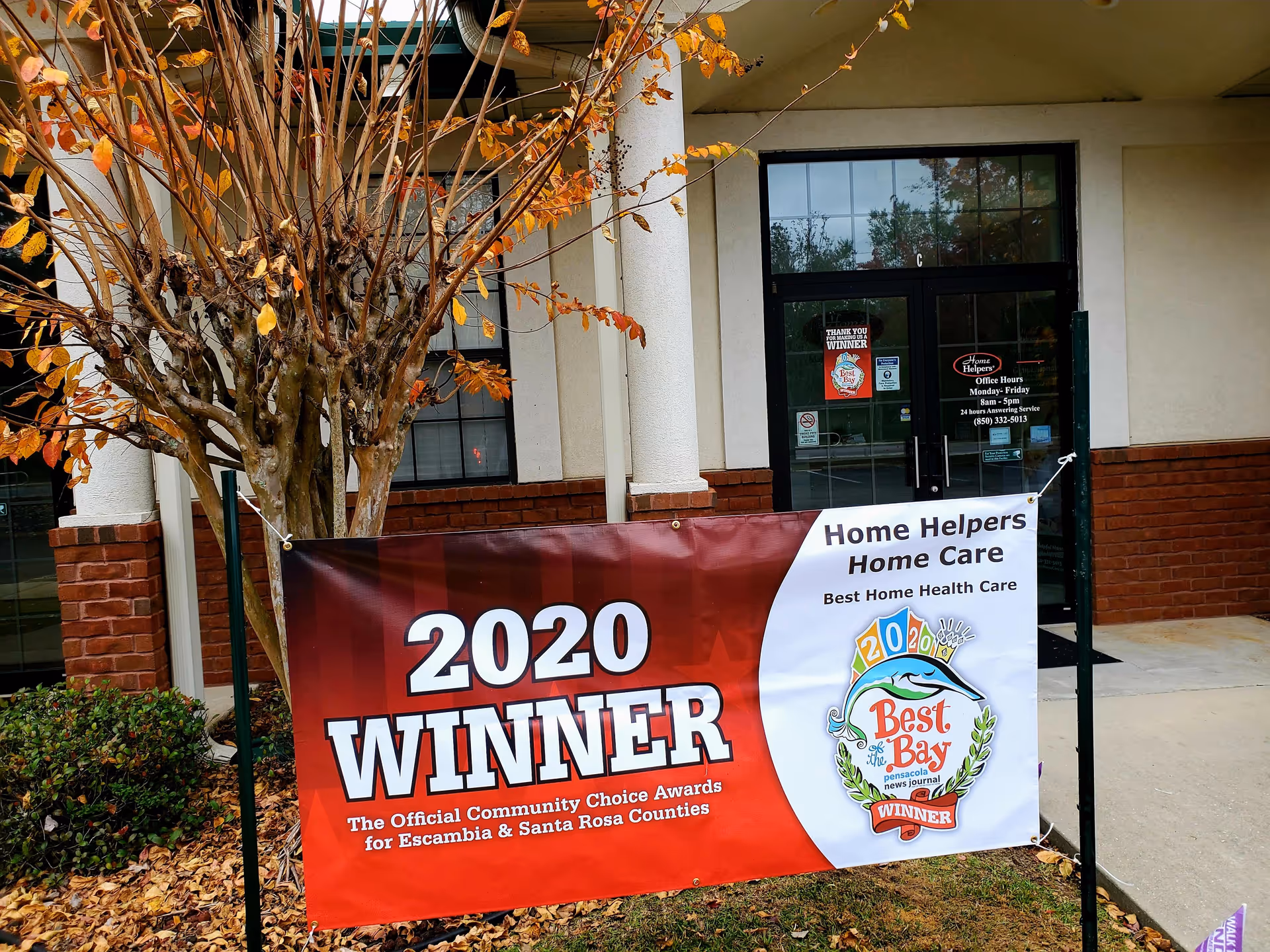 Exterior of Home Helpers Home Care Pensacola with a large 2020 WINNER banner at entrance