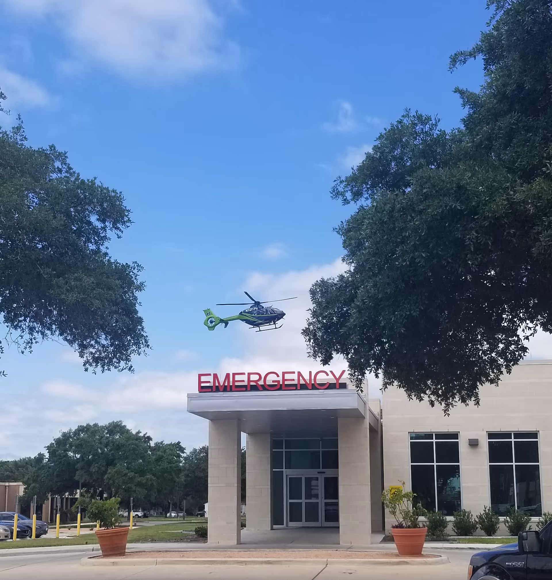 Front view of Citizens Medical Center emergency entrance with a helicopter landing nearby.