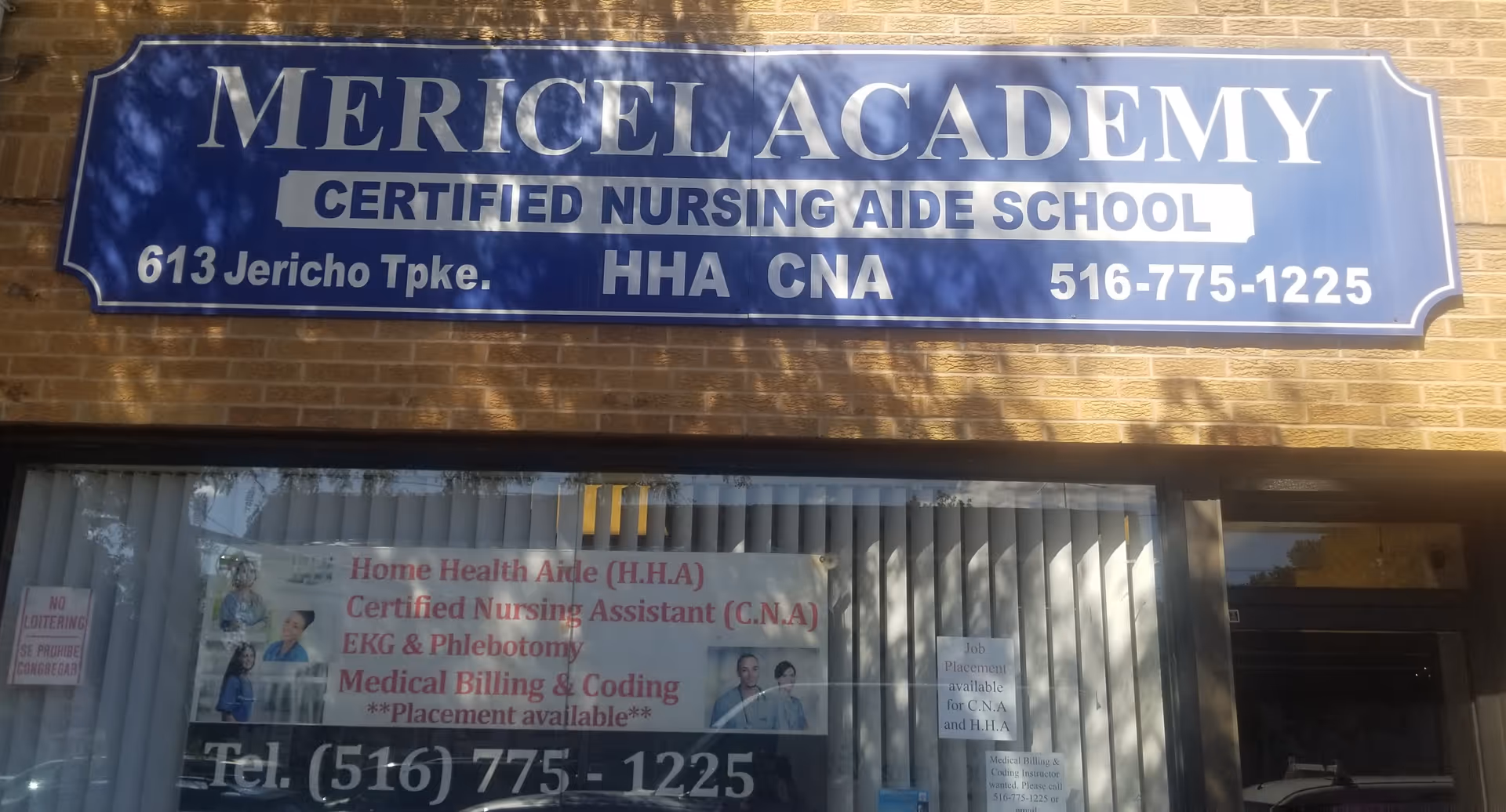 Blue sign reads Mericel Academy Certified Nursing Aide School on a brick building exterior.