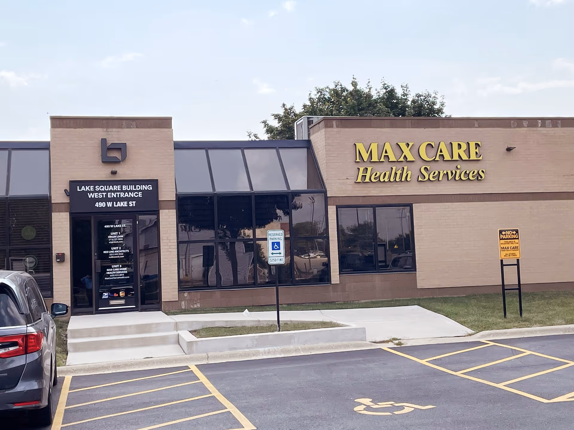 Exterior view of Max Care Health Services building with parking and a wheelchair symbol.