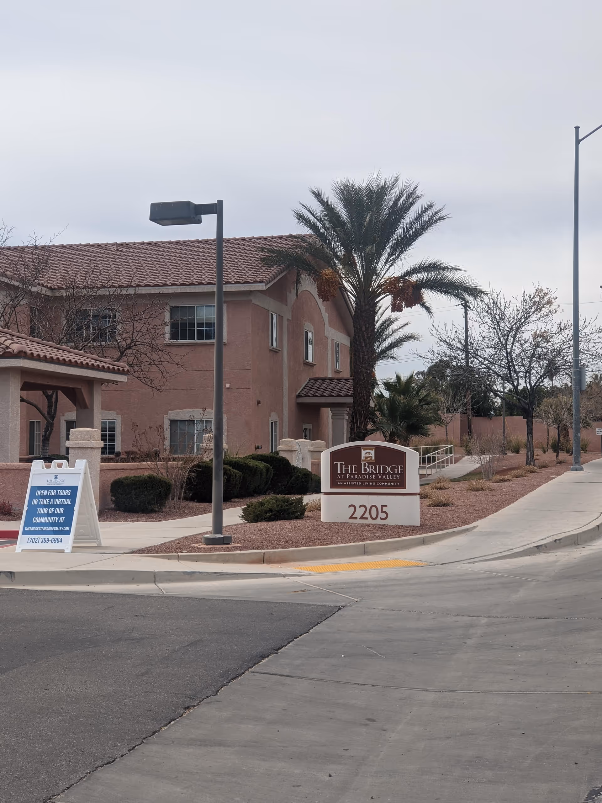 Exterior view shows The Bridge at Paradise Valley's tan building and sign.