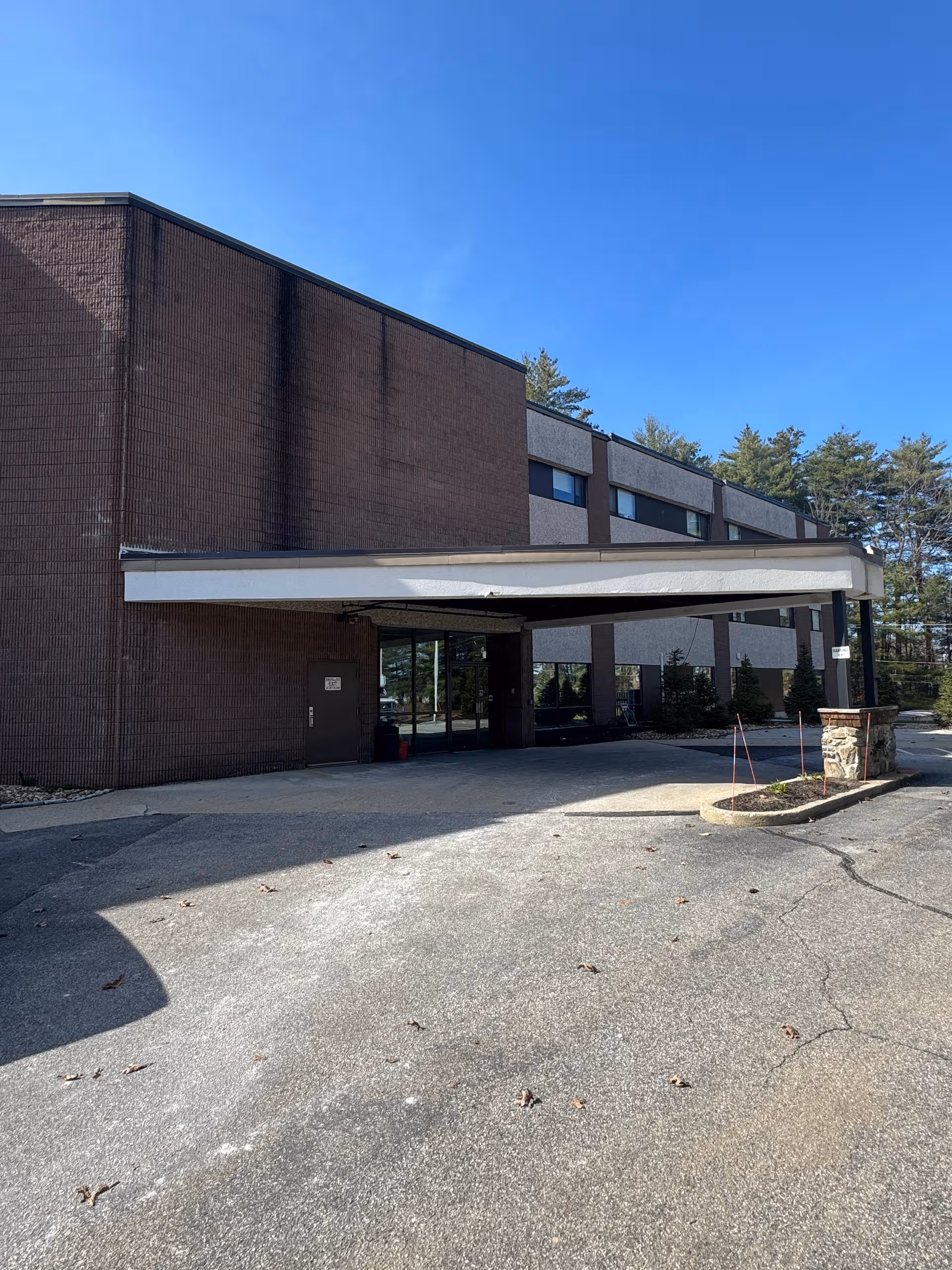 Brick senior living facility with a covered entrance and driveway.