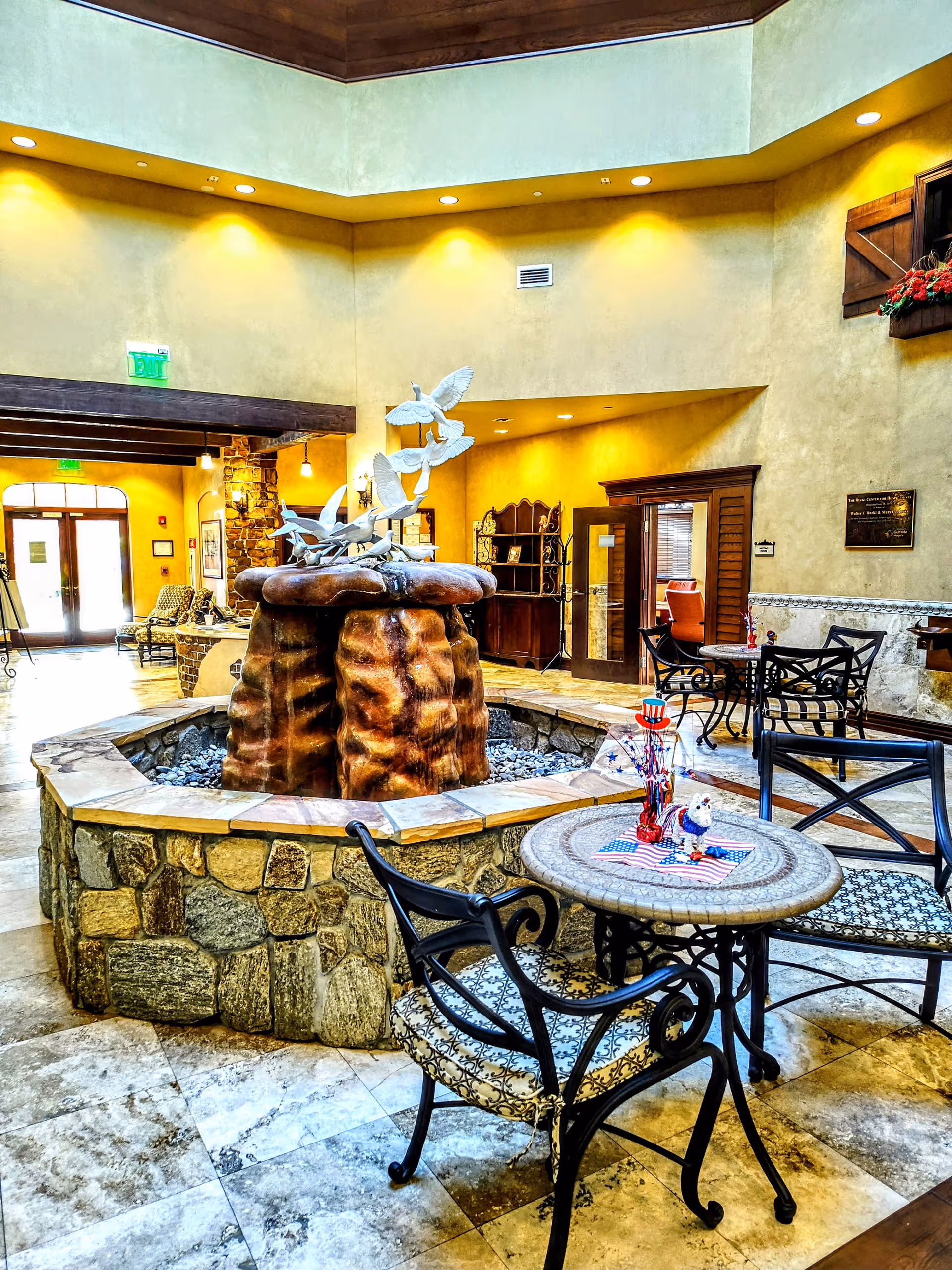 Inside a Gulfside Healthcare Services lobby featuring a stone fountain and wrought-iron seating.