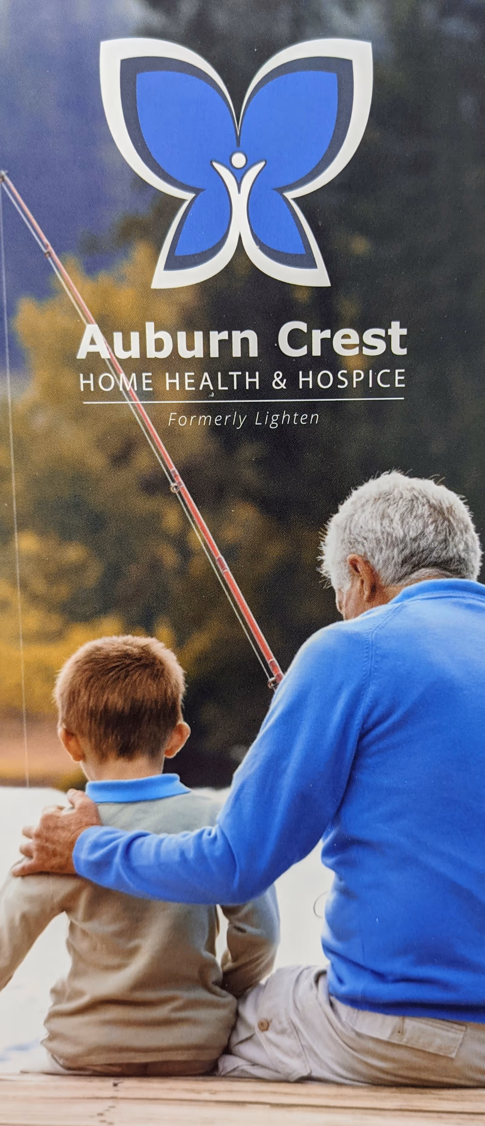 Outdoor banner for Auburn Crest Home Health and Hospice with logo and two people fishing