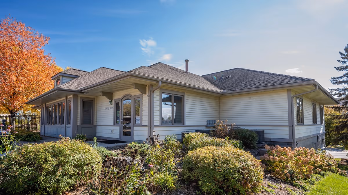 Exterior view of Cottage West by Three Links with landscaping and clear sky.
