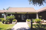 Exterior view of Haven Health Phoenix entrance with a covered walkway and landscaped planters.