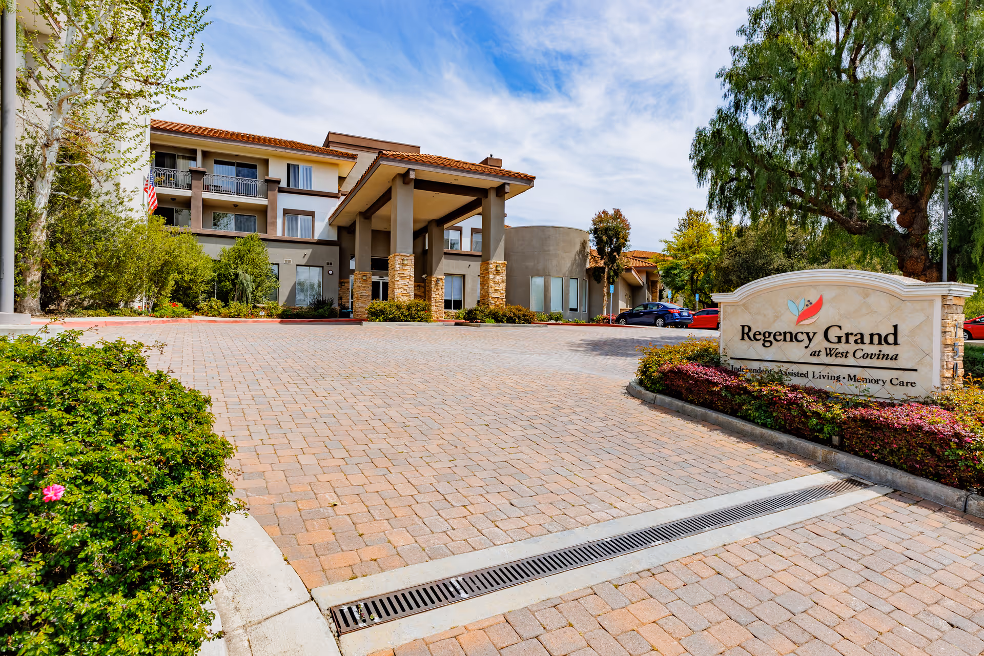 Exterior view of Regency Grand at West Covina with drive and entrance sign
