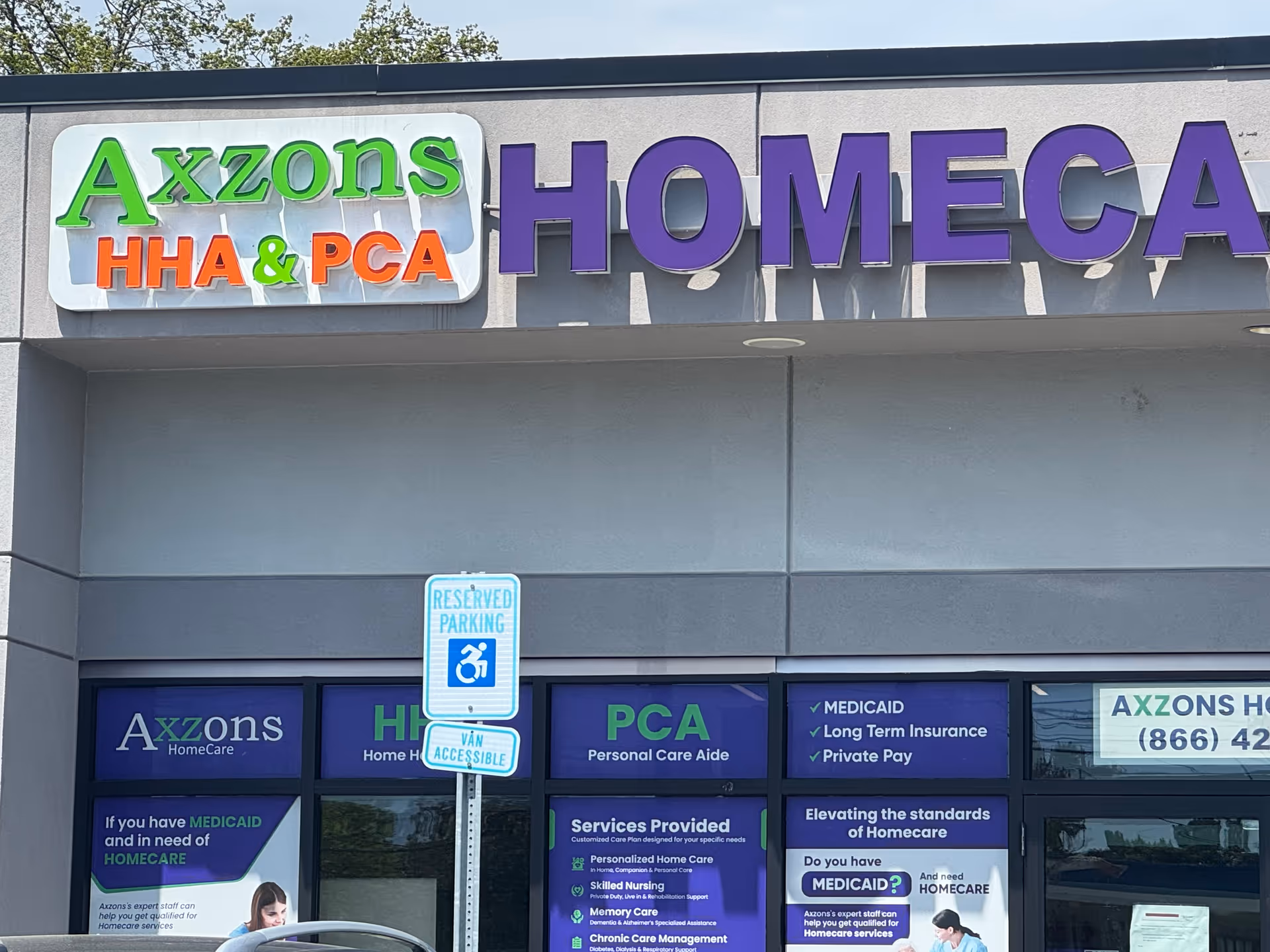 Exterior storefront displaying Axzons HomeCare sign and blue promotional window panels.