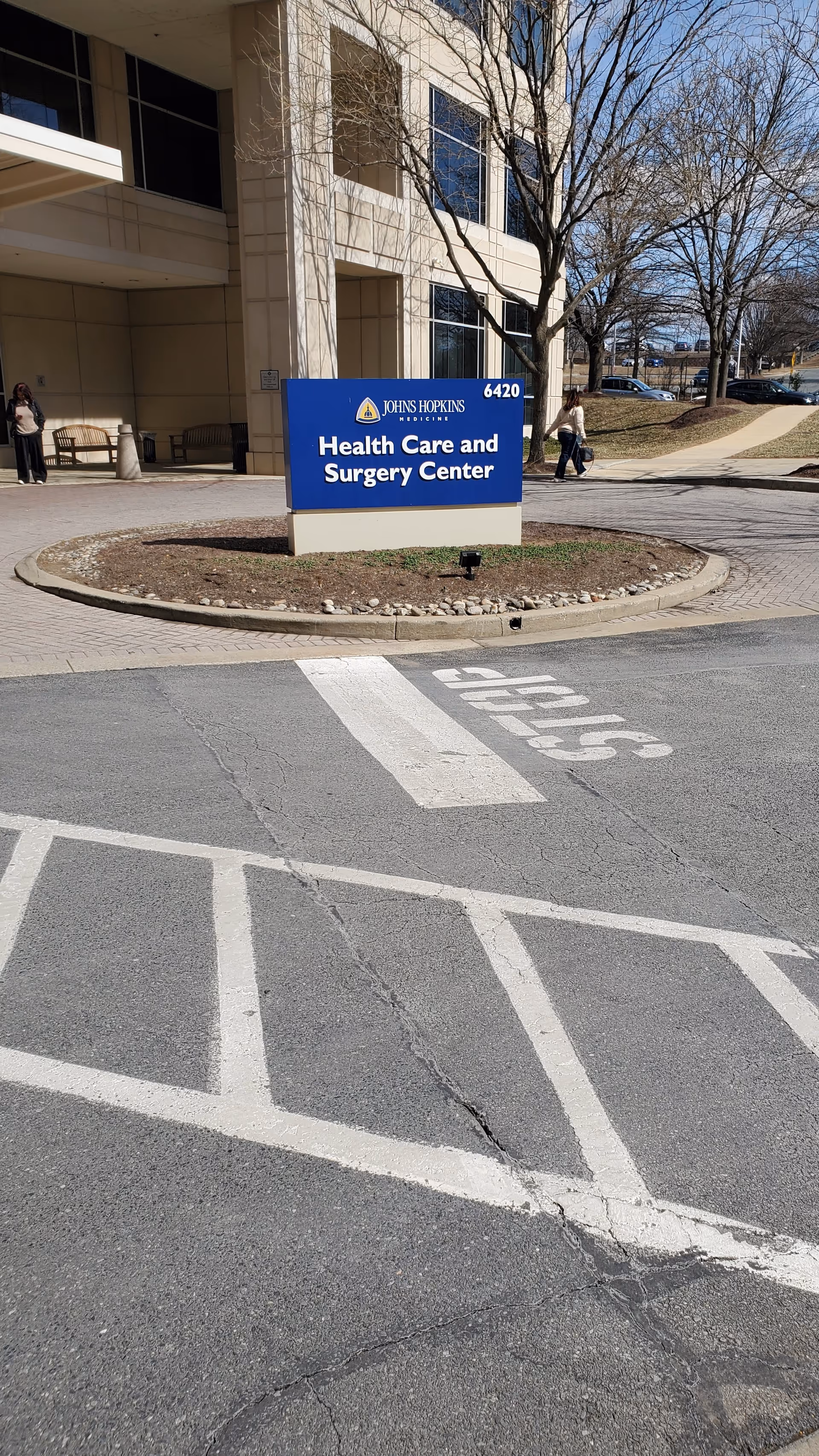 Exterior view of Johns Hopkins Health Care & Surgery Center with blue entrance sign.