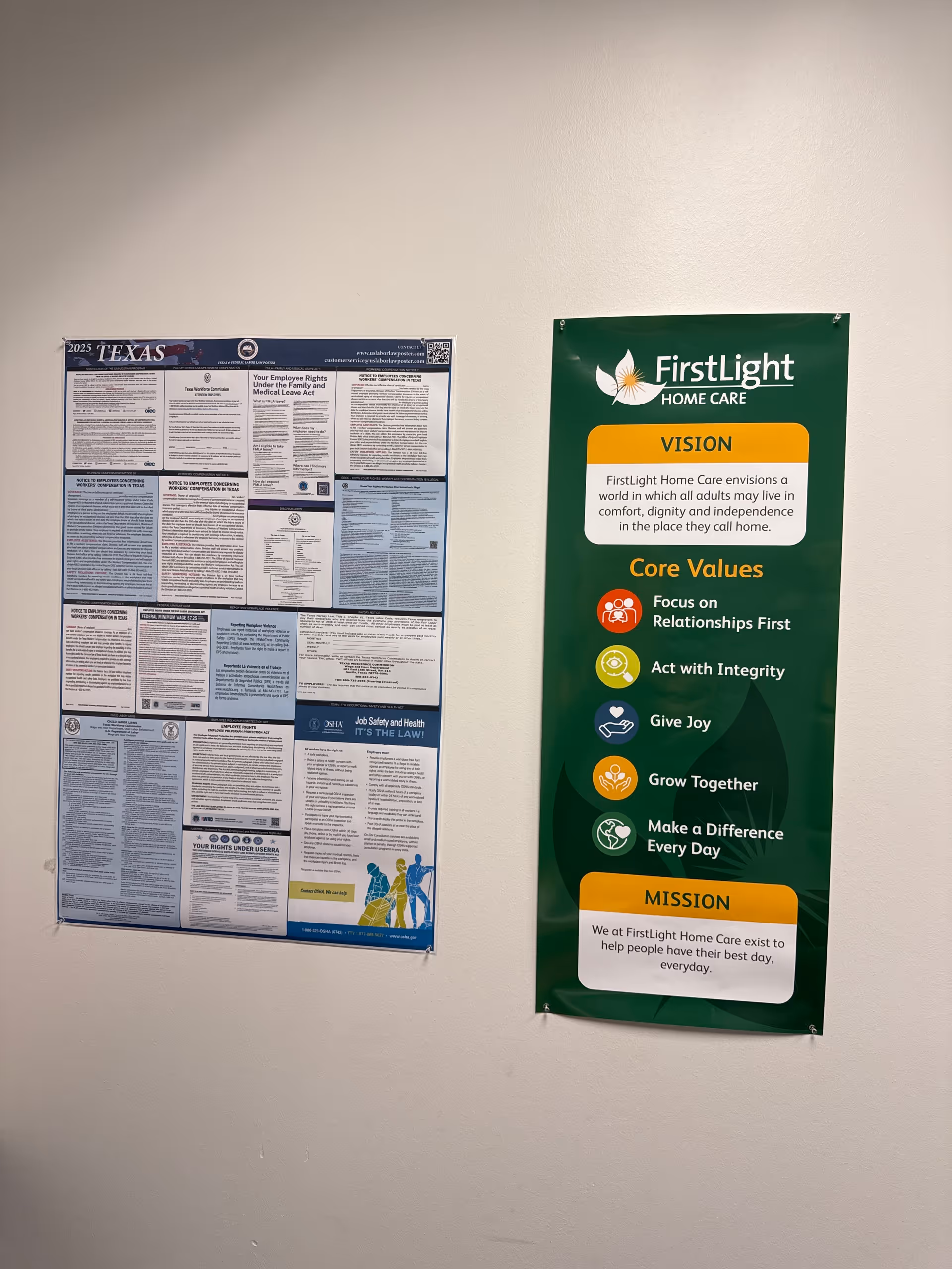 Two informational posters, including FirstLight signage, hang on a beige hallway wall.