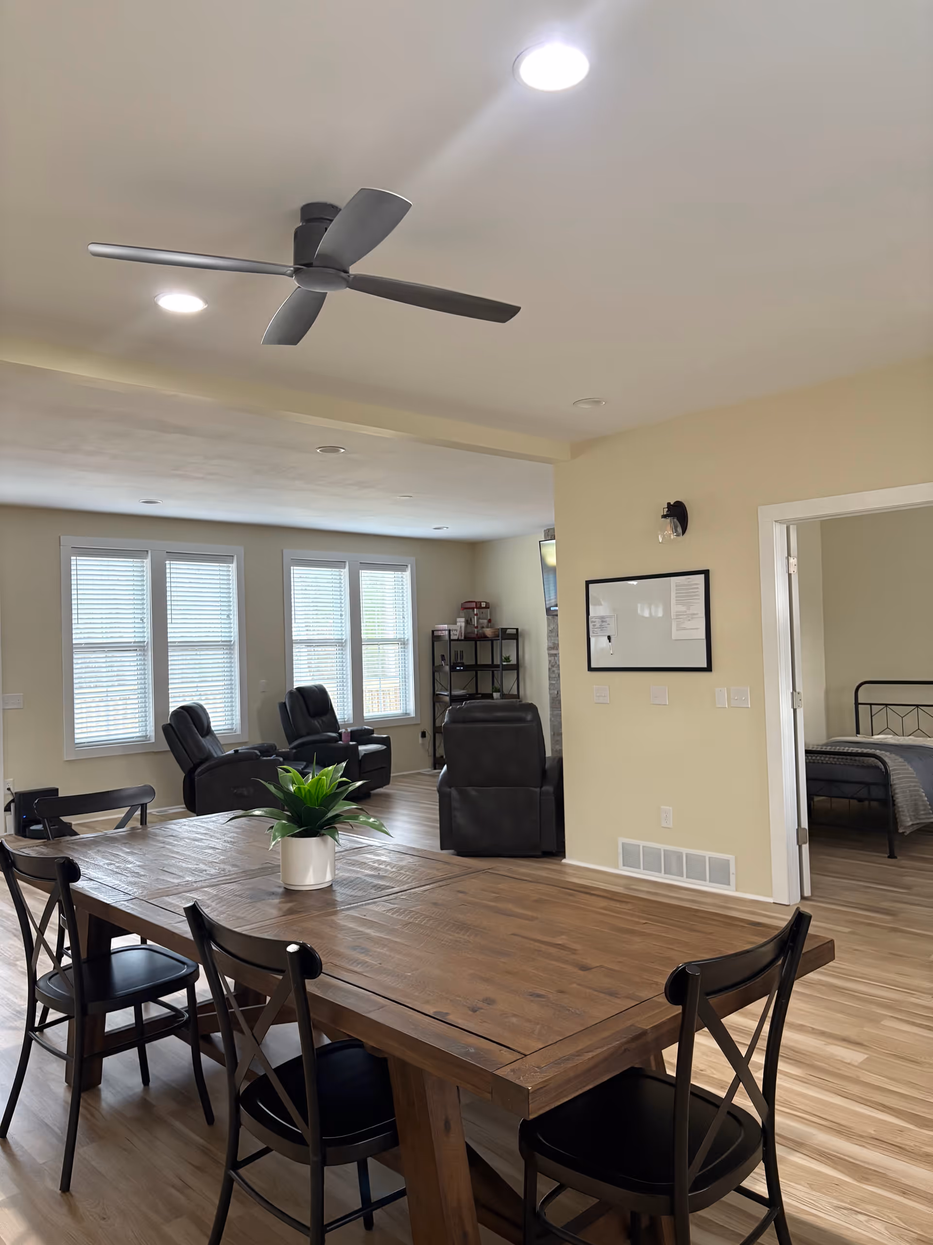 Spacious interior common area with a large wooden dining table and lounge chairs.