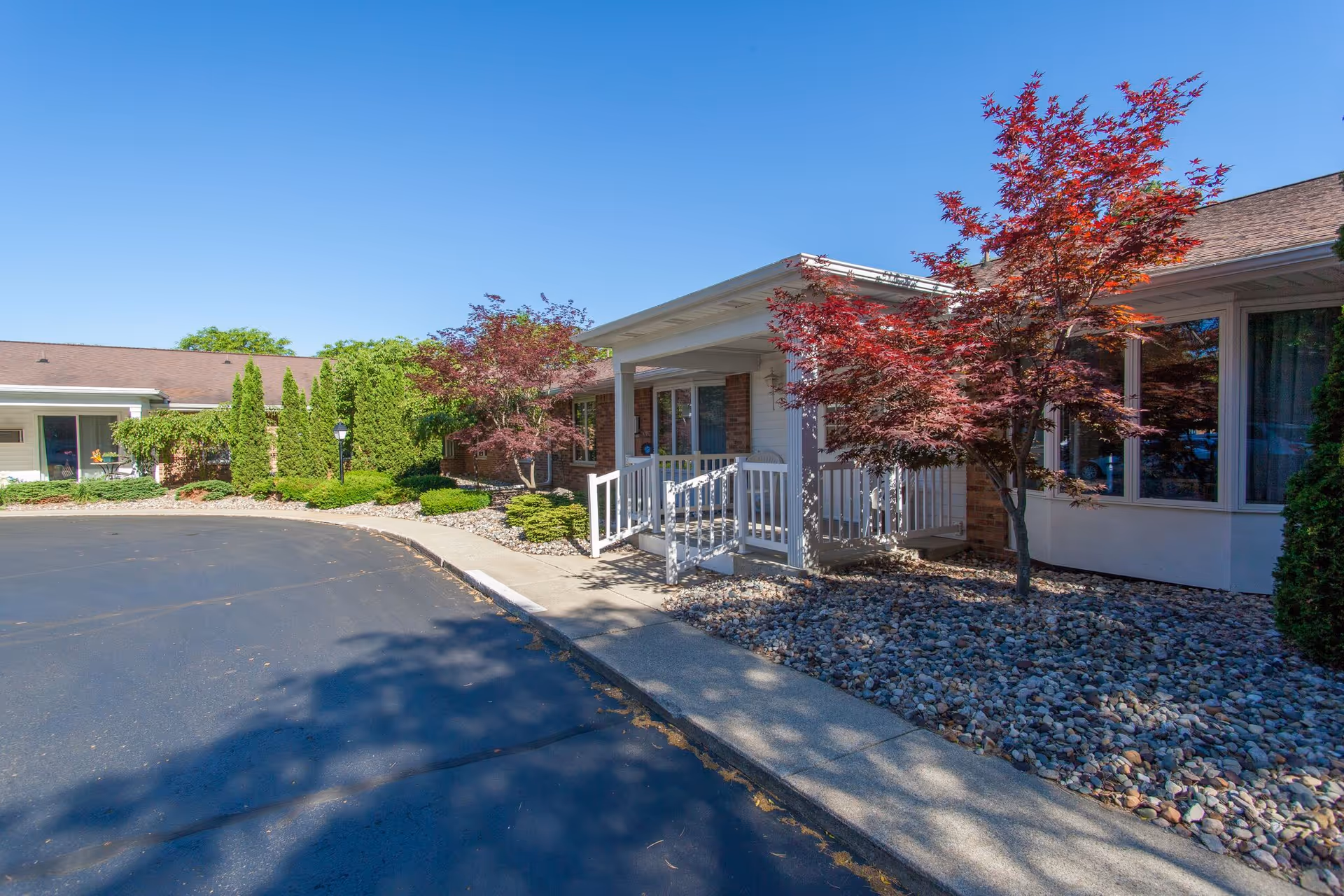 Exterior view of Ganton's Countryside Retirement Community entrance with landscaped walkway.