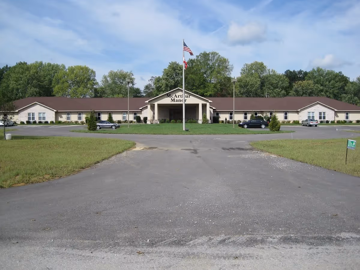 McArthur Manor Assisted Living exterior with a wide front entrance and parking.