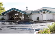 Exterior view of Edgewood Plantation Place facility with a covered entrance and parking lot.