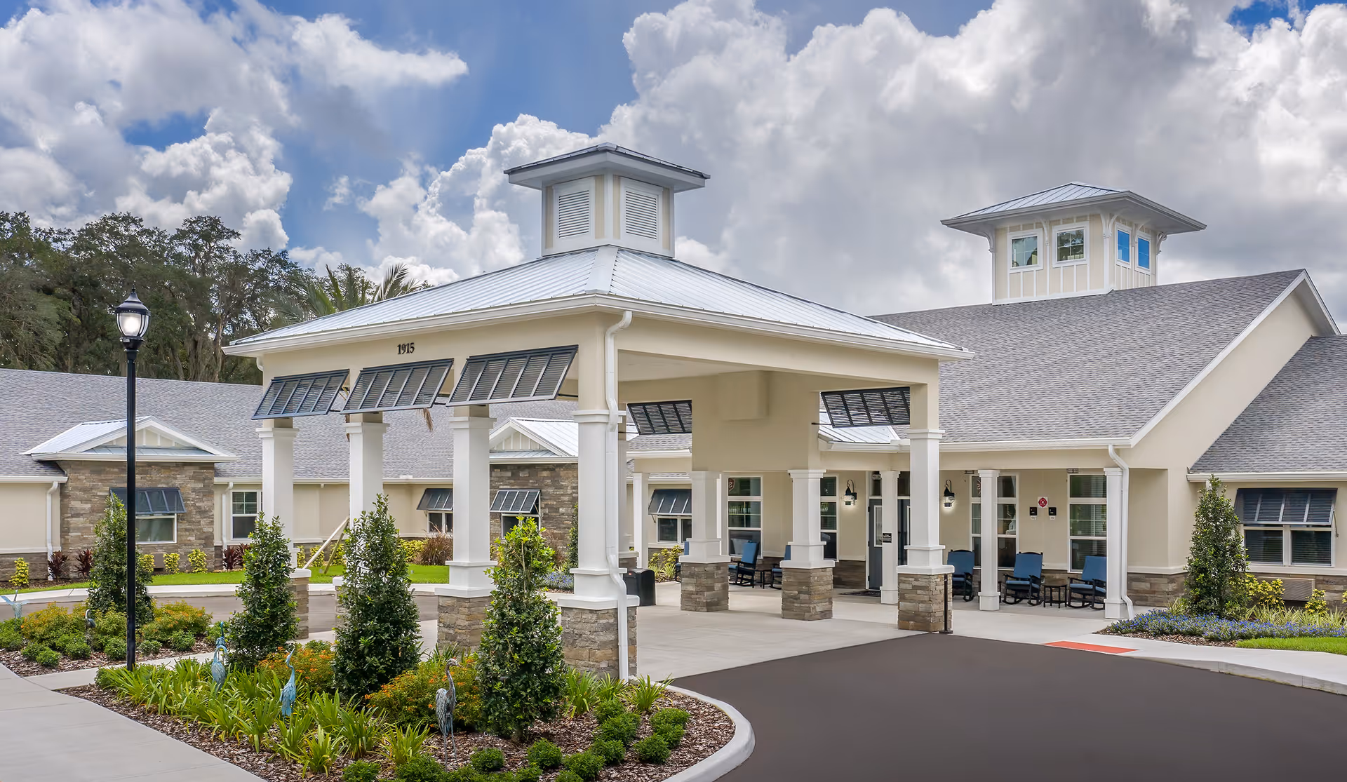 Front view of The Addison of Oviedo exterior with porte-cochere and landscaping
