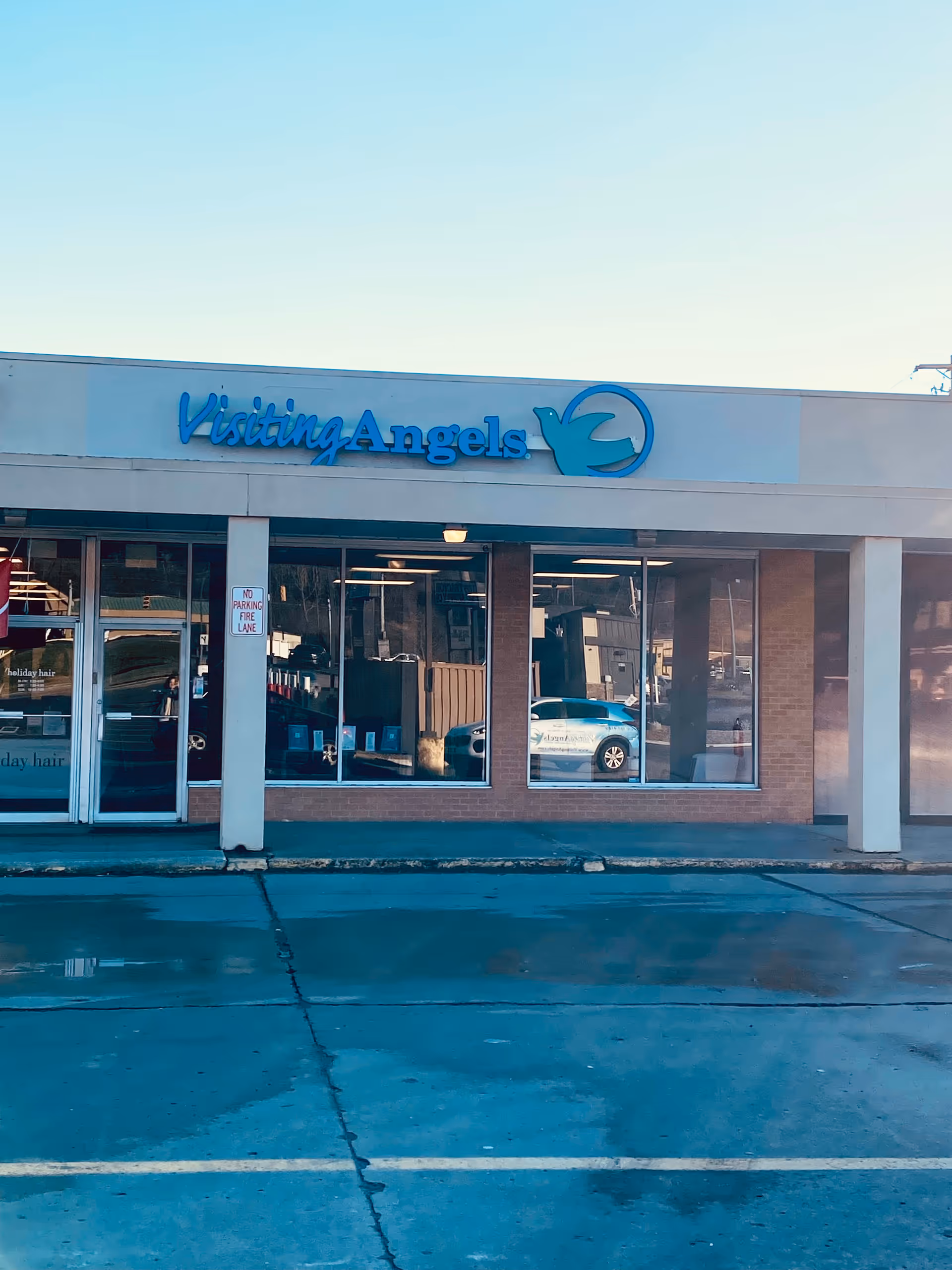 Front view of Visiting Angels Cambridge storefront with blue sign.