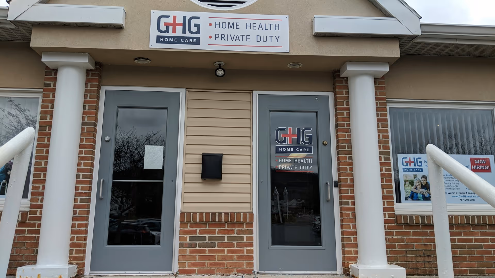 Front exterior of Global Healthcare Group LLC with two glass doors and signage.