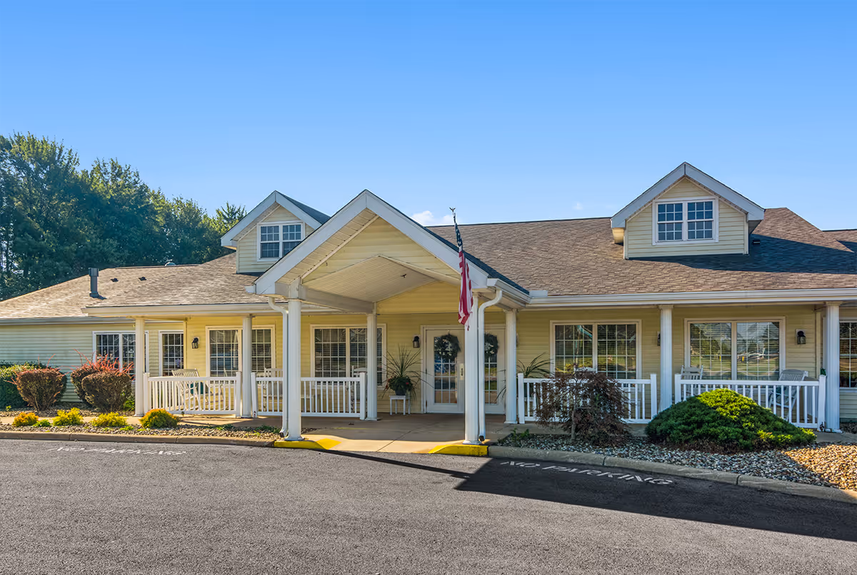 Portland Place senior living facility with a welcoming front entrance, covered porch, and landscaping.