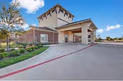 Exterior view of The Savannah at Gateway entrance with driveway and covered entry