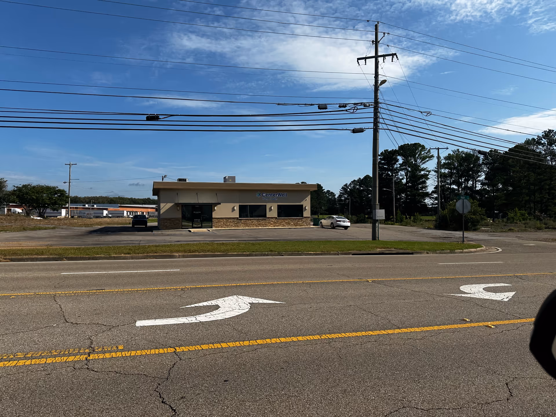CenterWell Home Health building on a street with power lines overhead.