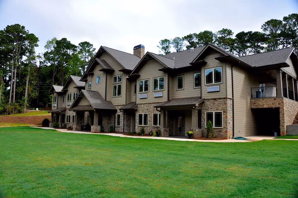Exterior view of Eternal Hope Hospice facility with multiple units, stone accents, and lawn.