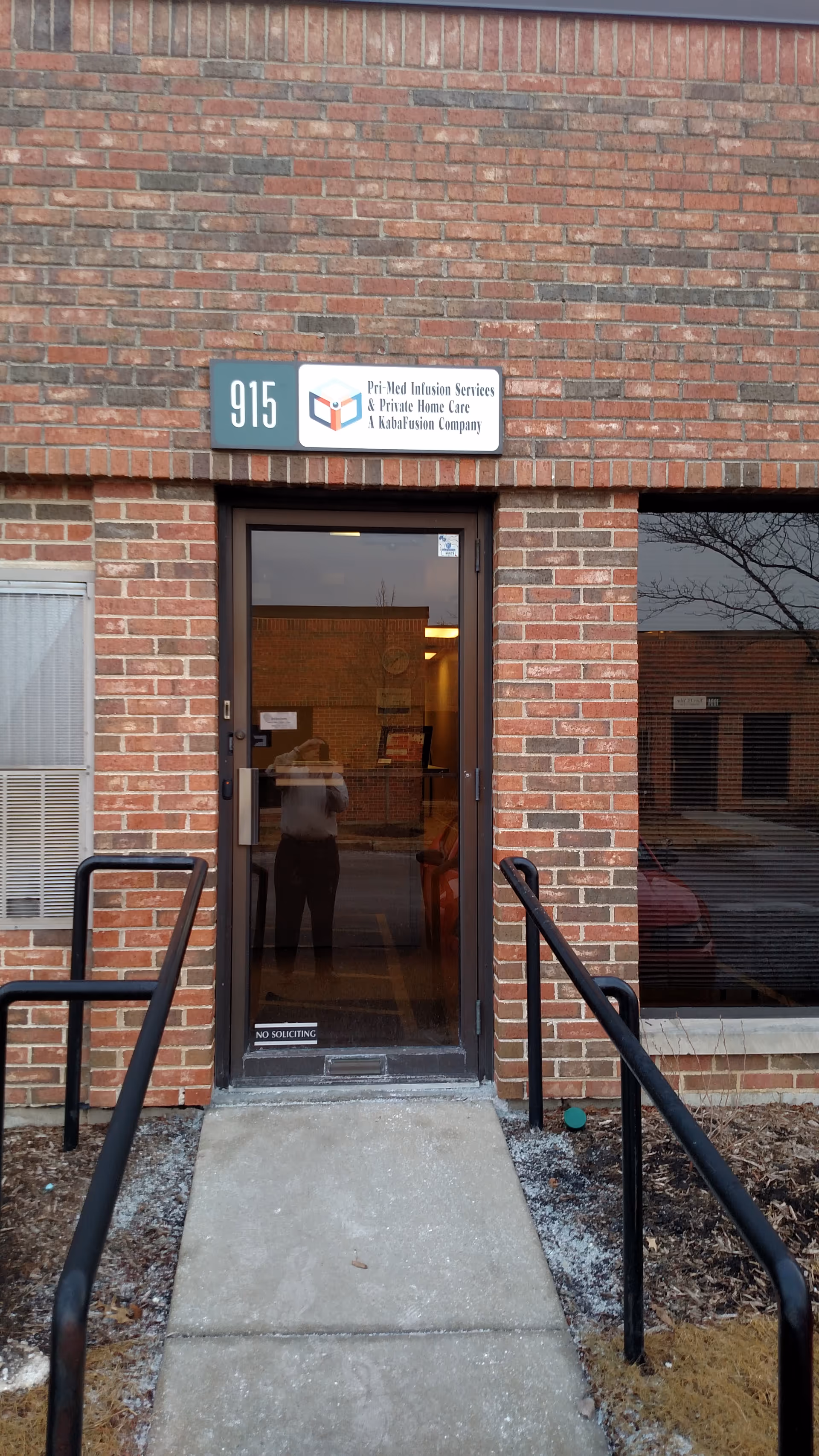 Brick exterior entrance with glass door, wheelchair ramp, and signage for KabaFusion.
