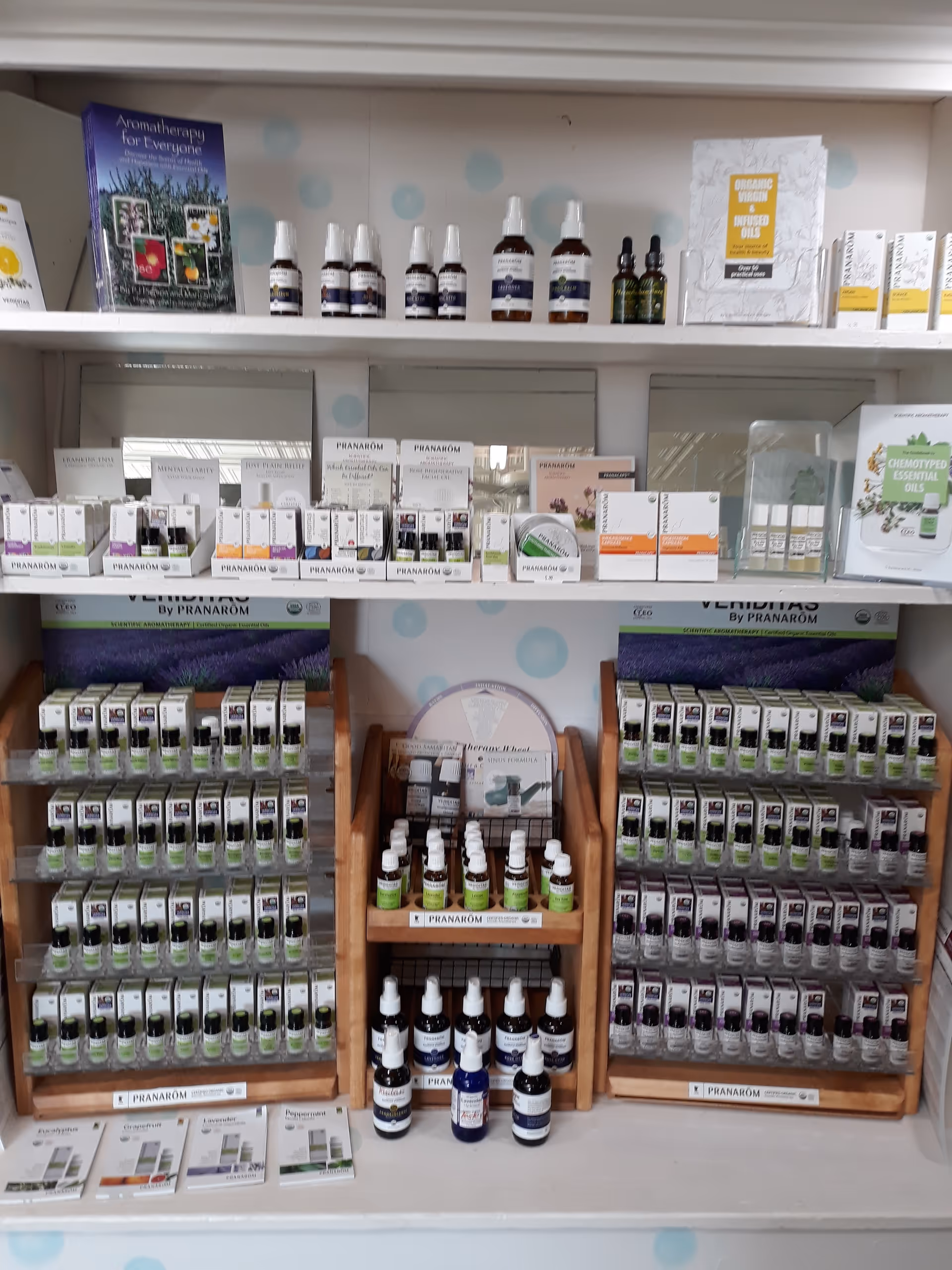 Interior shelves display assorted essential oils and wellness products.