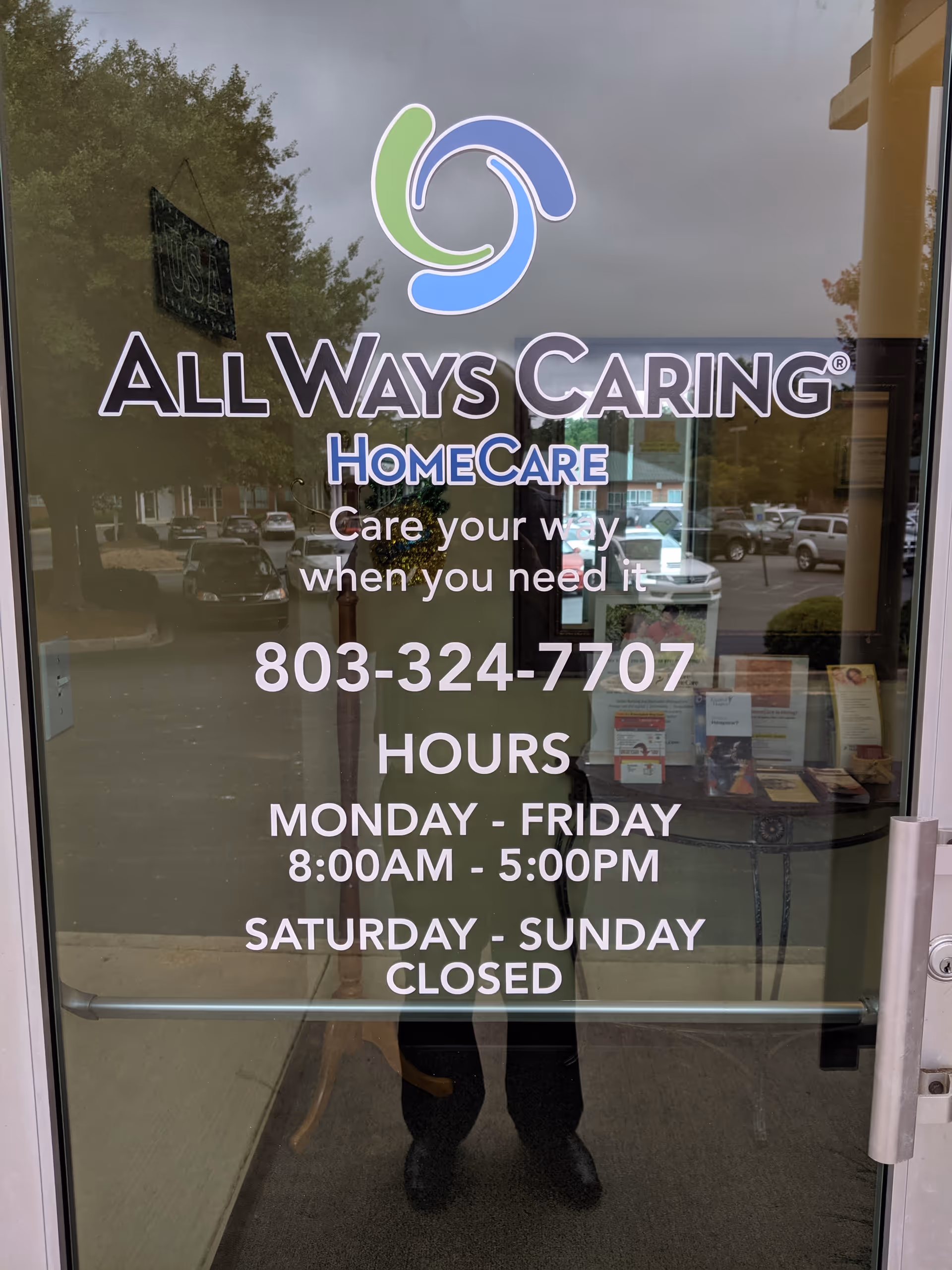 Glass door shows All Ways Caring HomeCare logo and hours for the entrance.