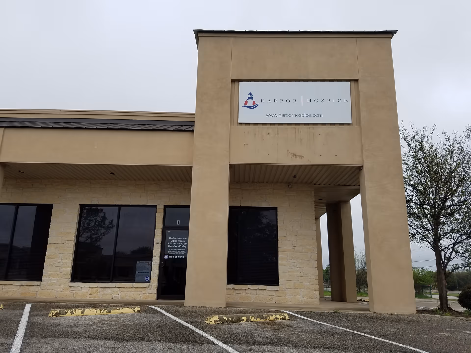 Beige building exterior with Harbor Hospice sign above entrance