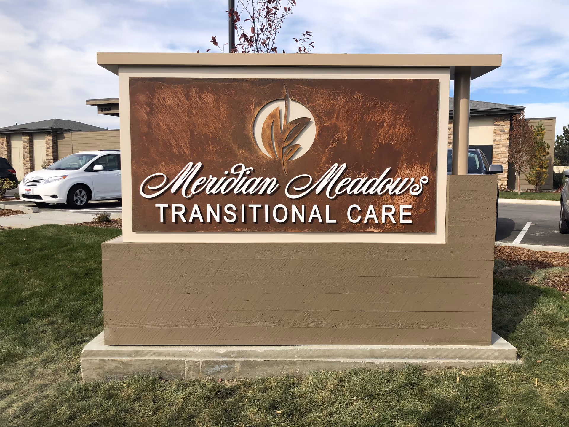 A large front sign reads Meridian Meadows Transitional Care, with parking and buildings in the background.