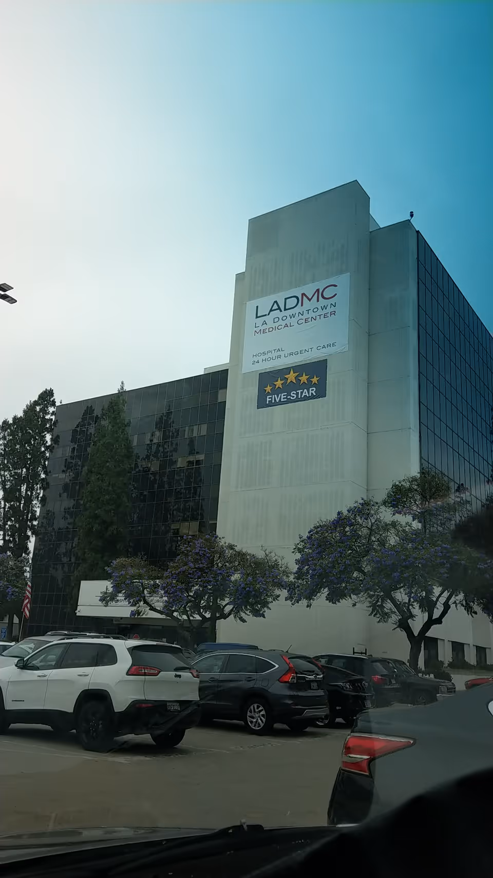 Exterior view of a large medical center building with LADMC sign in downtown area