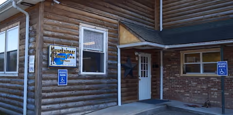 Exterior view of Mountaineer Home Care Services building with signs and porch.