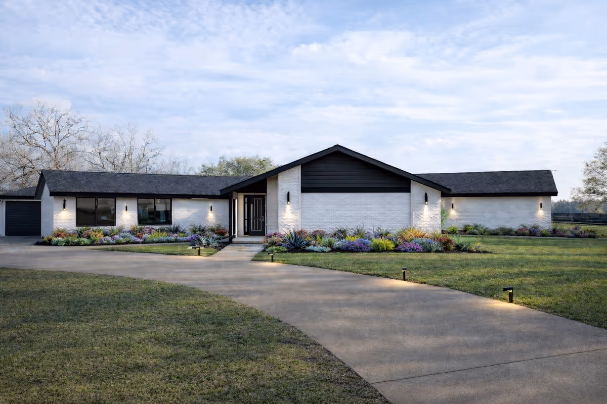 Single-story modern facility with white brick exterior and landscaped front yard.