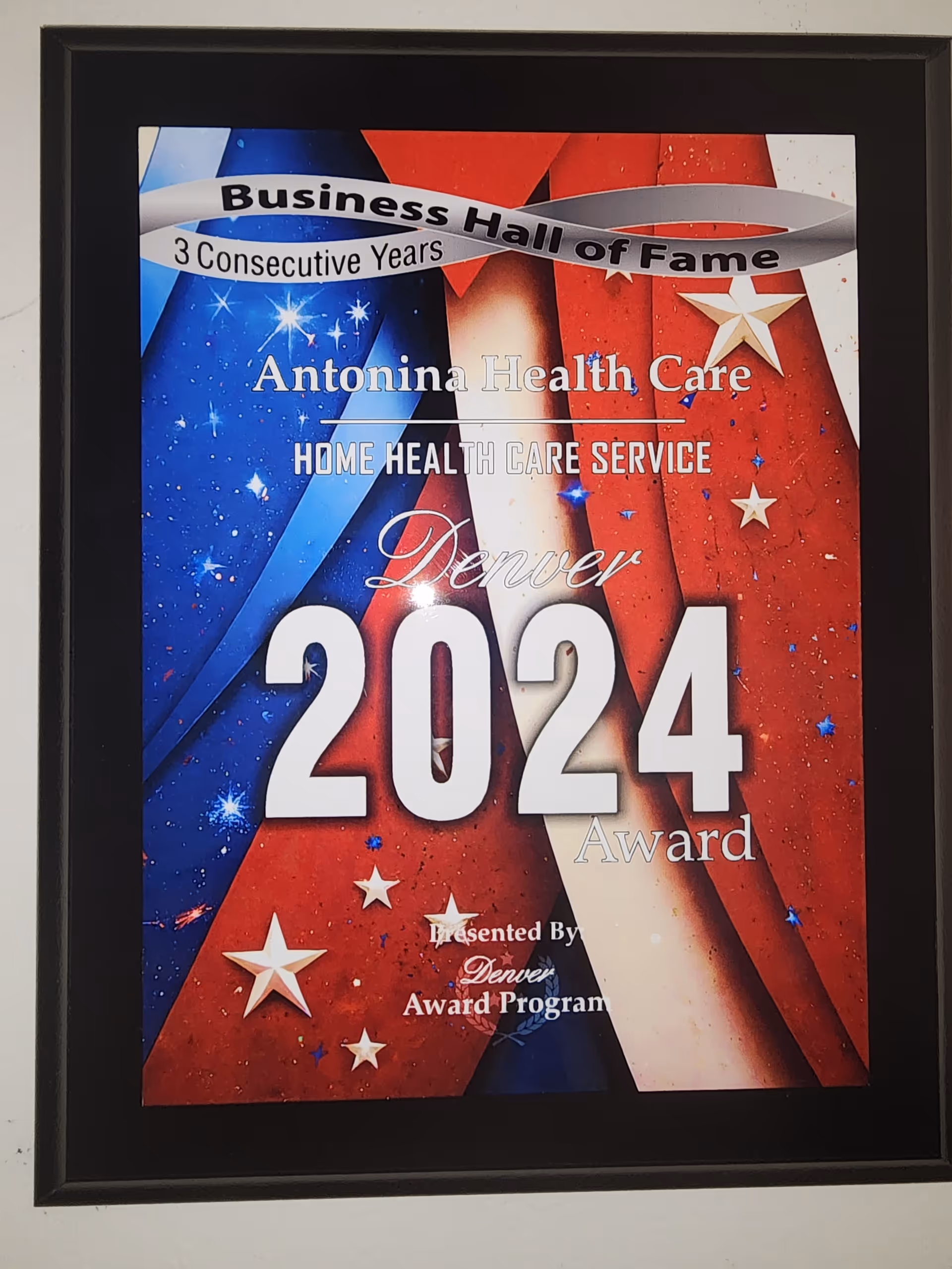 Framed poster on a wall announcing a 2024 Antonina Health Care award.